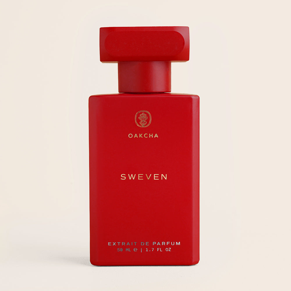 Red perfume bottle labeled 'Torrid Day' by Oakcha on a beige background
