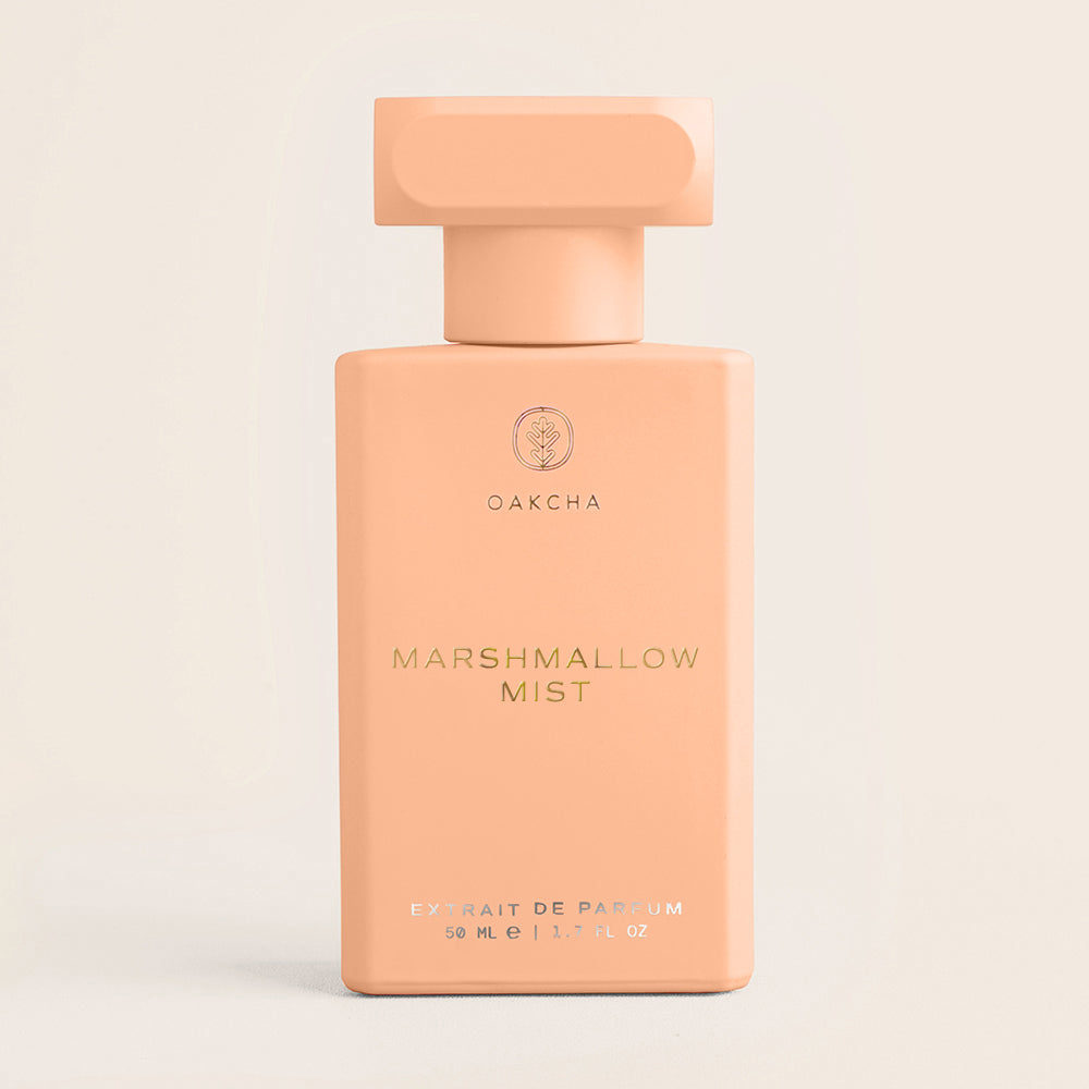 Perfume bottle labeled 'Marshmallow Mist' by OakCha on a beige background