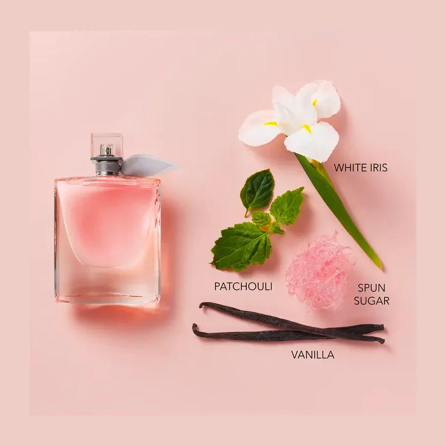 Pink perfume bottle with floral and vanilla elements on a pink background