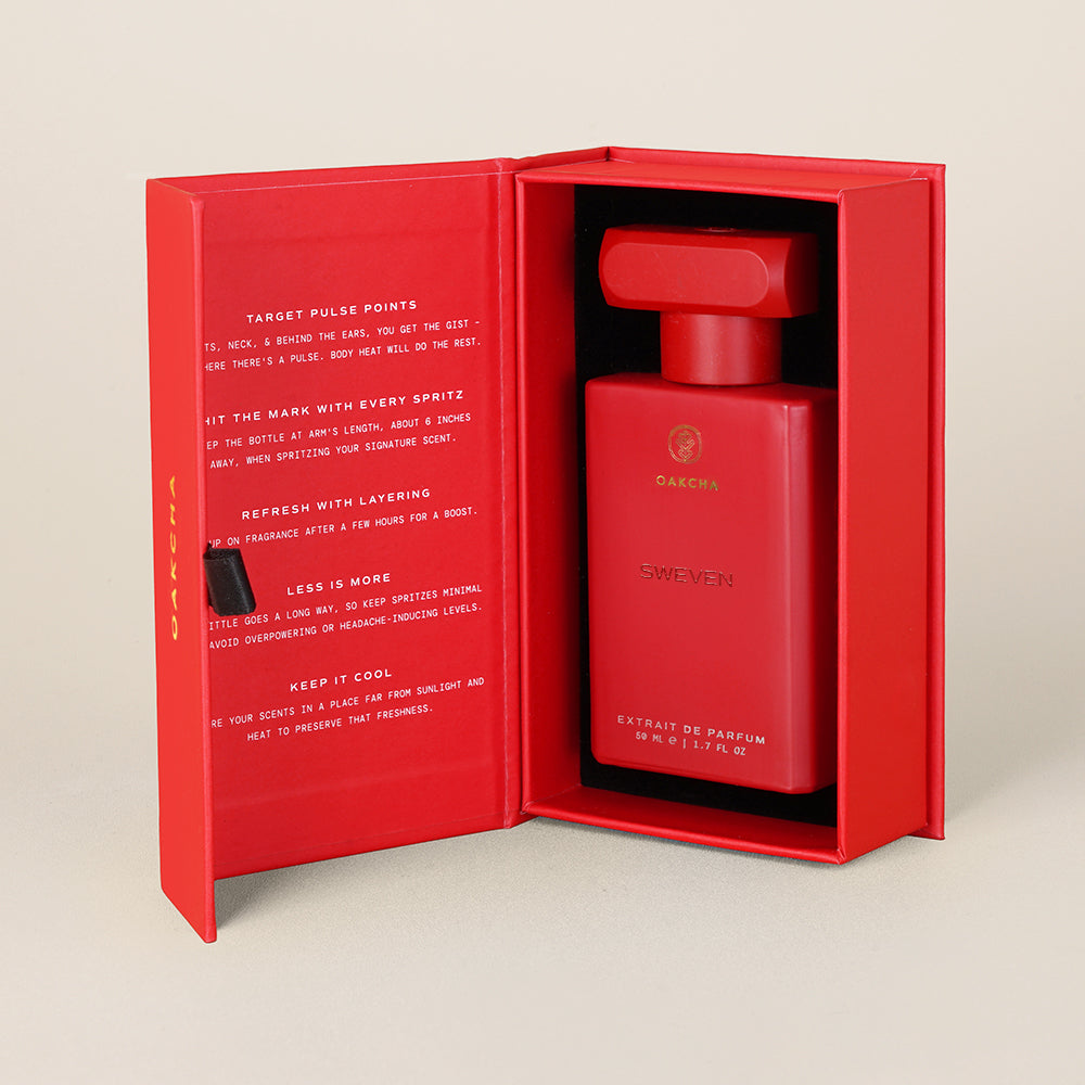 Red perfume bottle in an open red box on a beige background